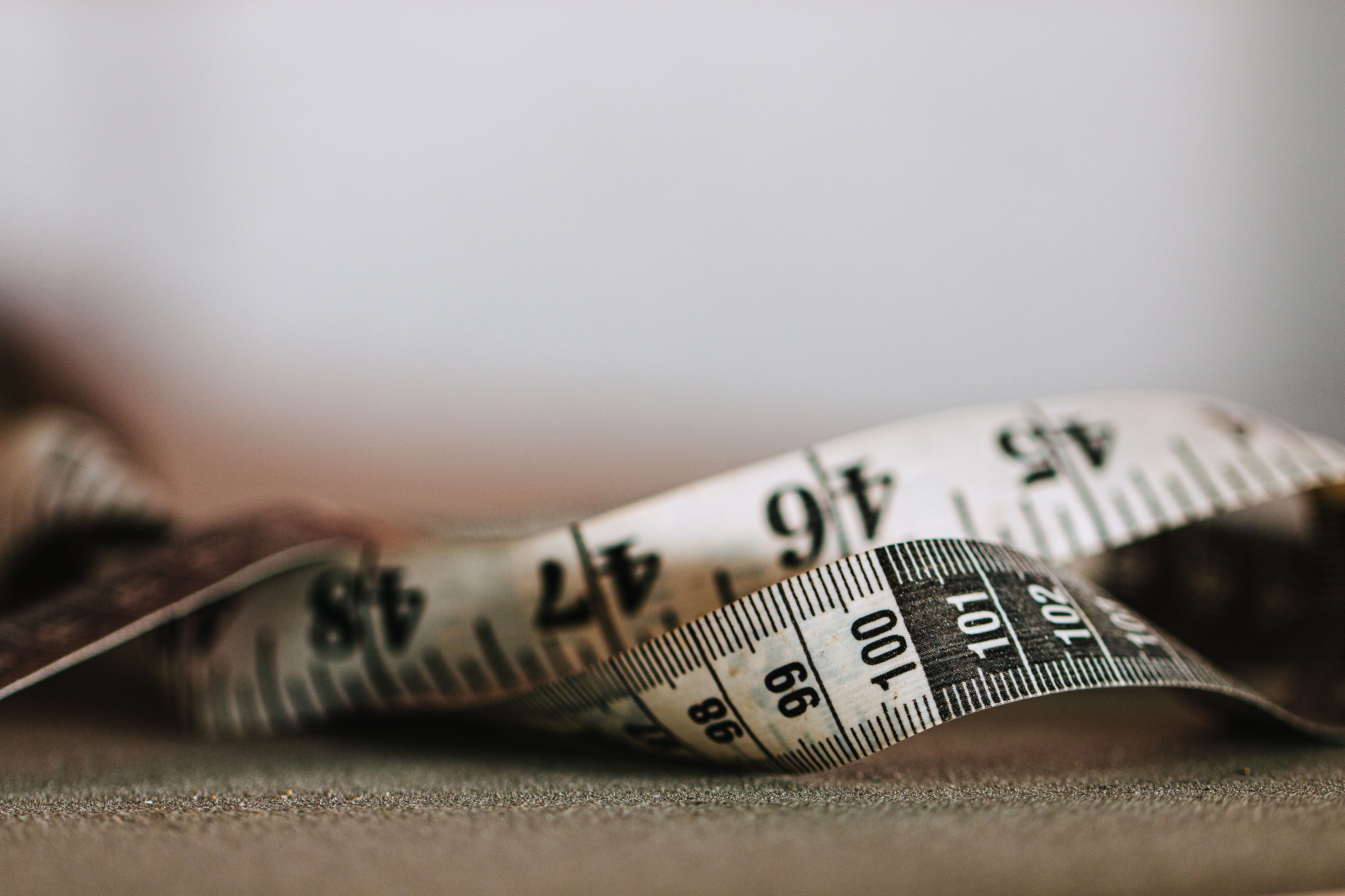 Close-up of a tape measure, used to measure shelf space before buying a book nook