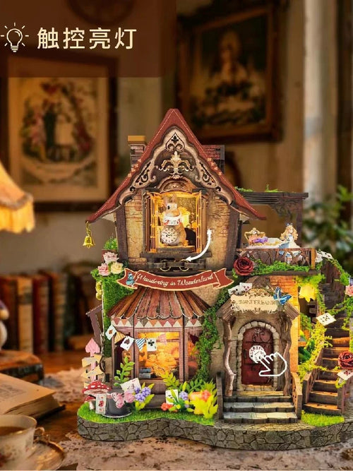 Assembled Alice in Wonderland DIY cottage with mossy stone base, curved staircase, roses and playing cards