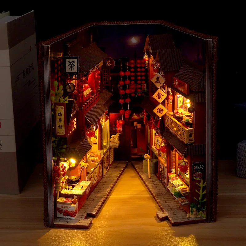 Night market street book nook kit lit up at night on a wooden table