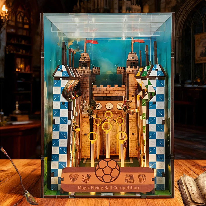 Front view of the Quidditch pitch diorama showing three golden hoops, a scoreboard, and checkered house-colored towers